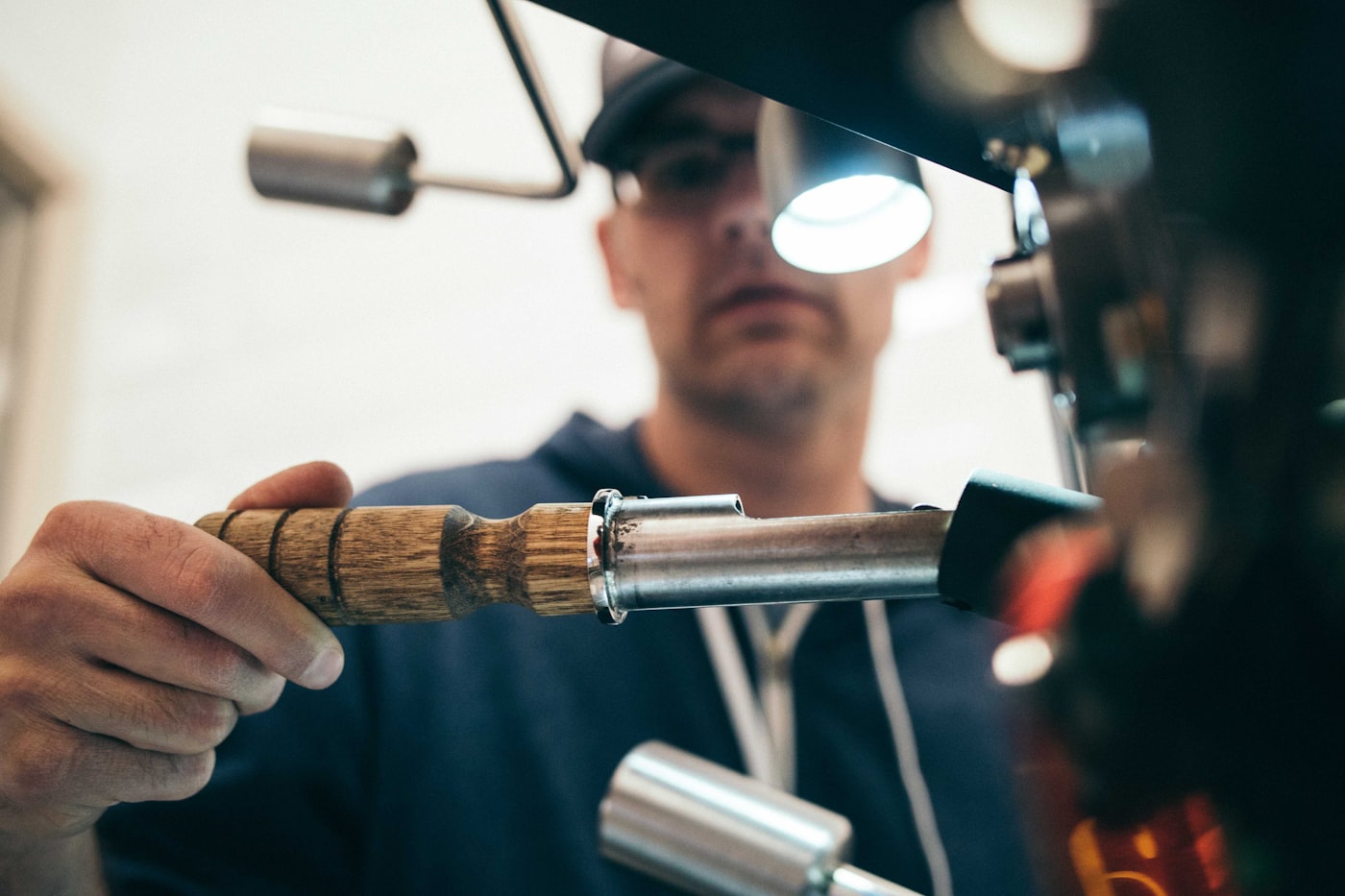 A WOW technician focused on servicing equipment with a work light